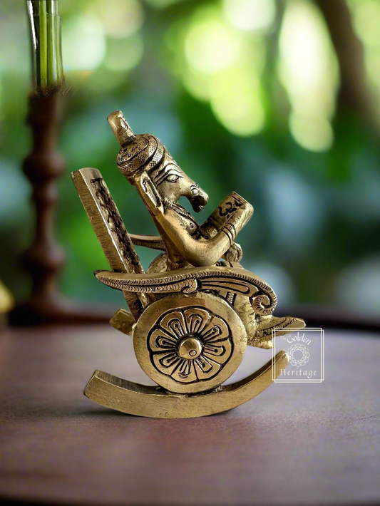 Ganesha sitting on rocking chair & reading book - The Golden Heritage #
