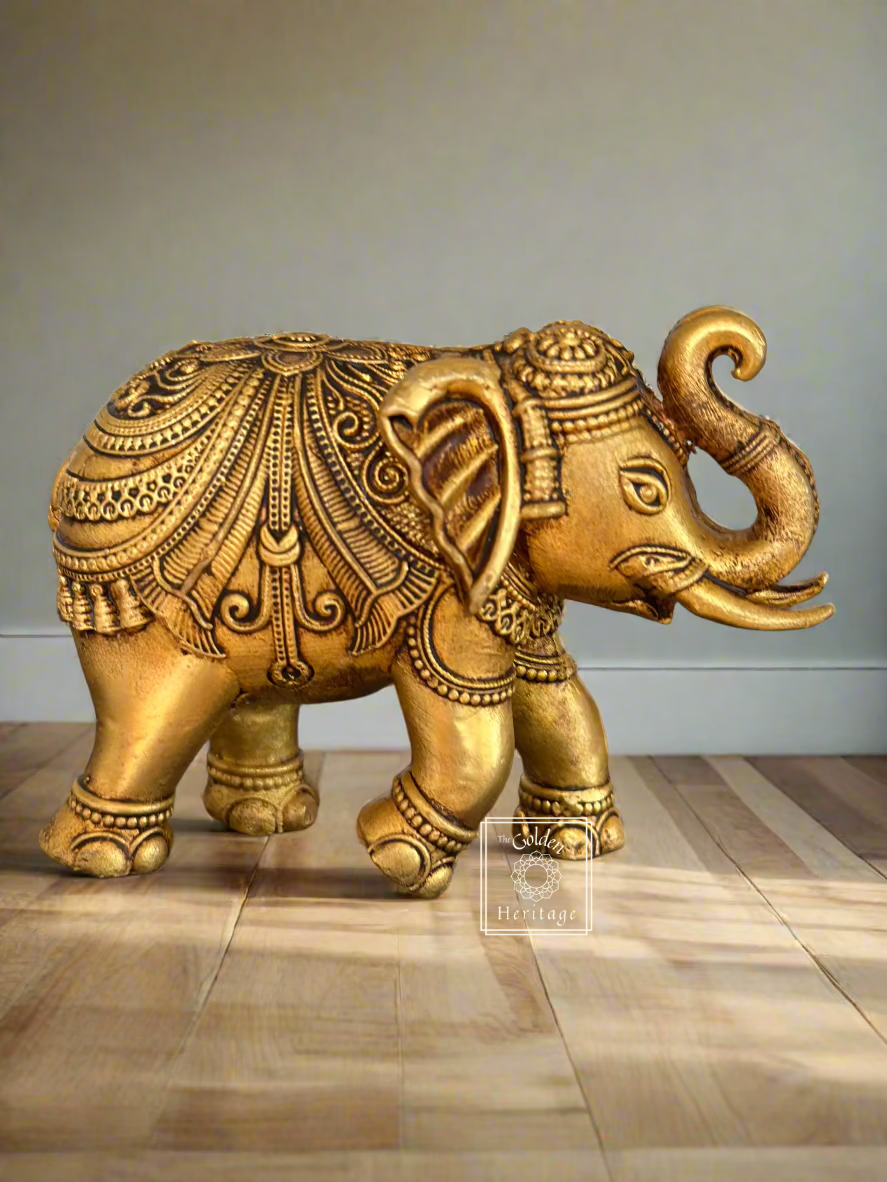 Handmade brass elephant figurine symbolizing strength and wisdom, standing on a wooden floor, 6 inches tall.