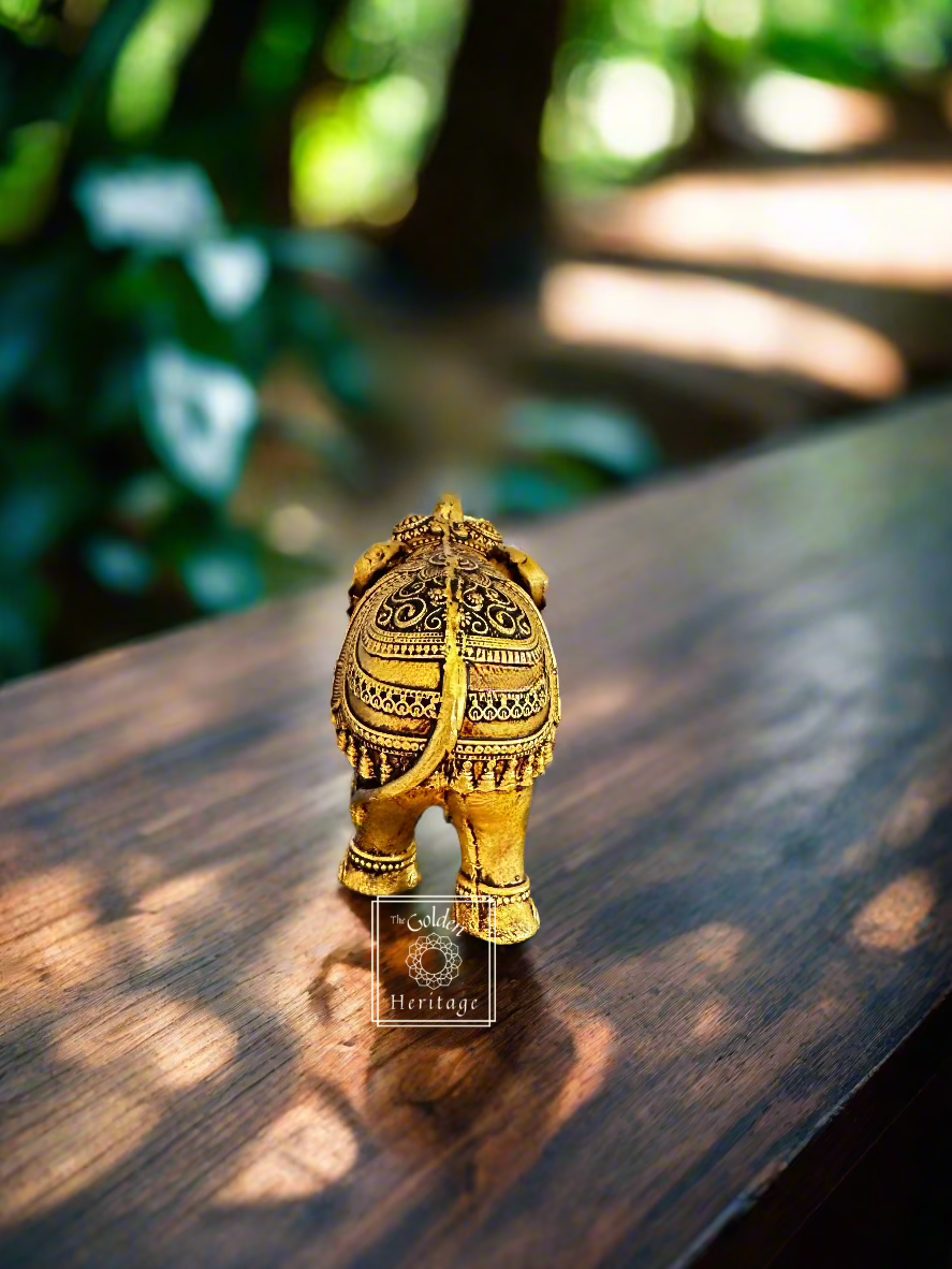 Handmade brass elephant figurine showcasing intricate detailing, representing strength and good luck, 6 inches tall.