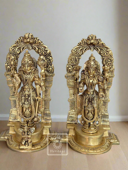 A set of two brass idols of Lakshmi-Narayana, depicting the deities with ornate headdresses and multiple arms, holding different symbols.
