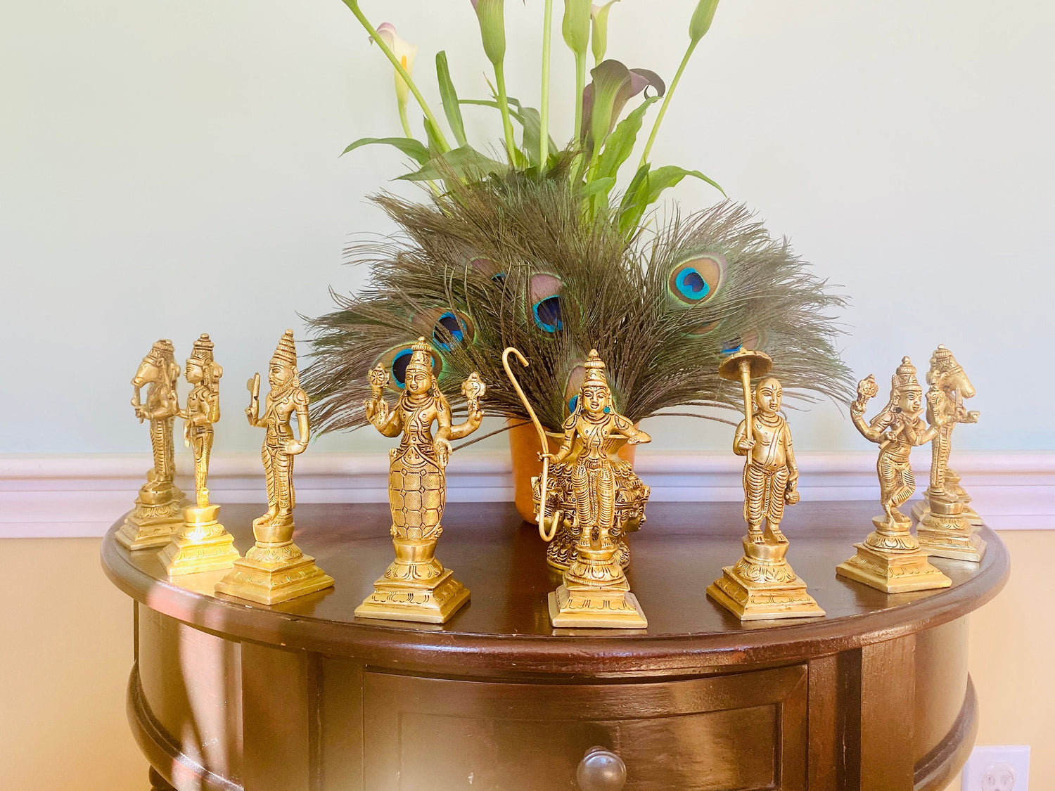 A set of brass statues representing the ten avatars of Lord Vishnu, displayed on a wooden table.Ten Incarnations of Lord Vishnu (Matsya, Kurma, Varaha, Narasimha, Vamana, Parashurama, Rama, Balarama, Krishna and Kalki.)