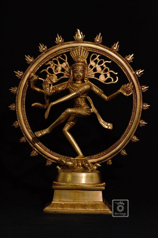 A brass statue of Nataraja, representing Lord Shiva as the cosmic dancer, with a golden finish.